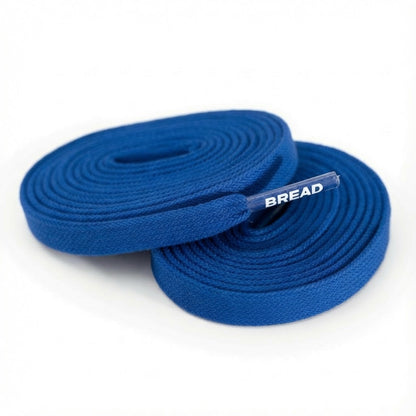 Two coiled blue fabric shoelaces with clear plastic tips featuring white BREAD text on a white background.