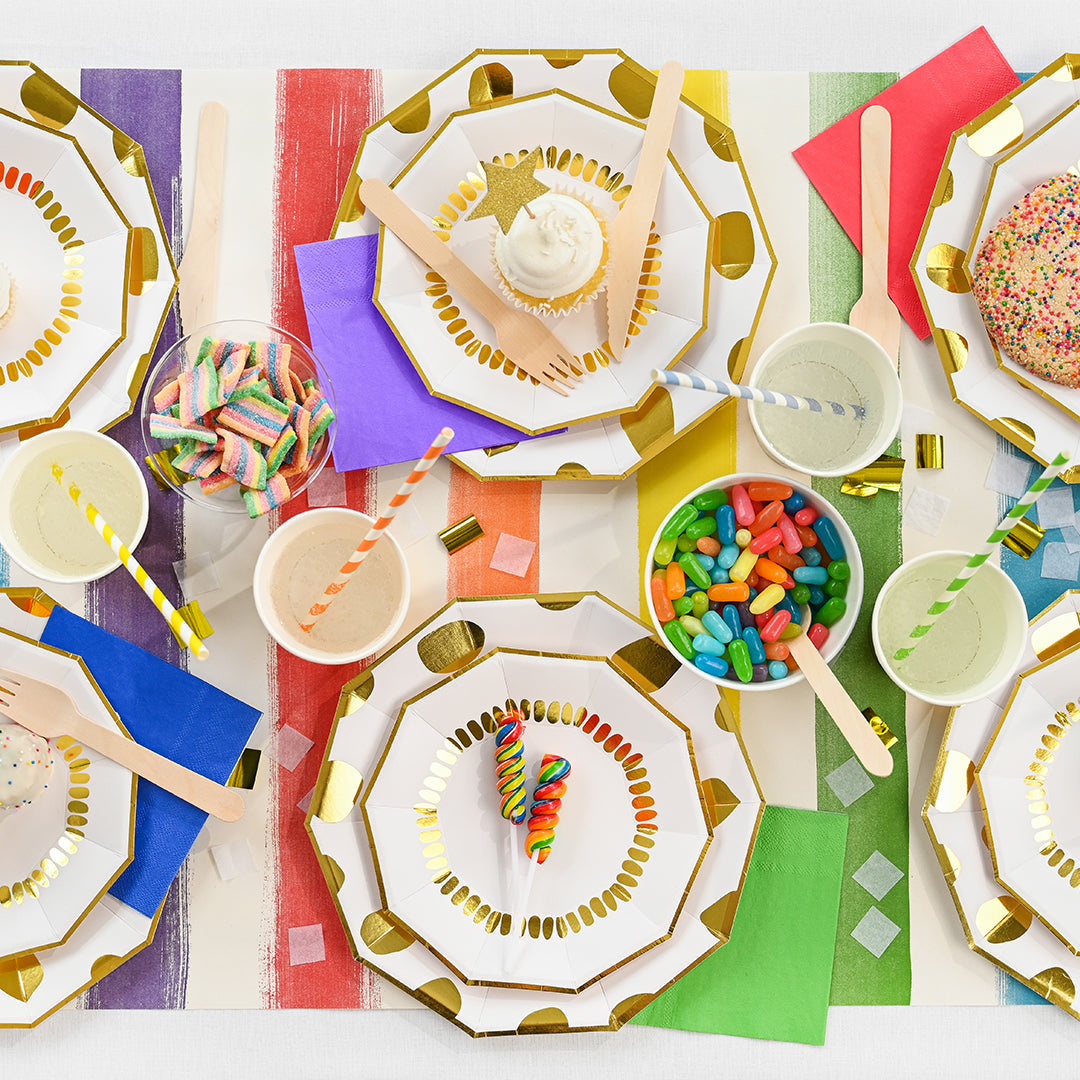 Party tablespace featuring rainbow color striped paper drinking straws