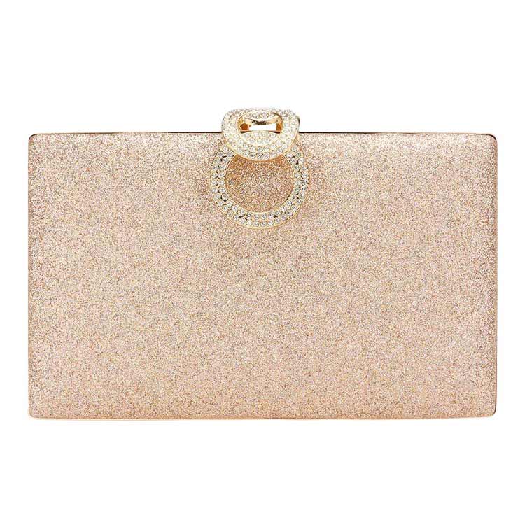 Glittery clutch bag with a decorative ring on a white background