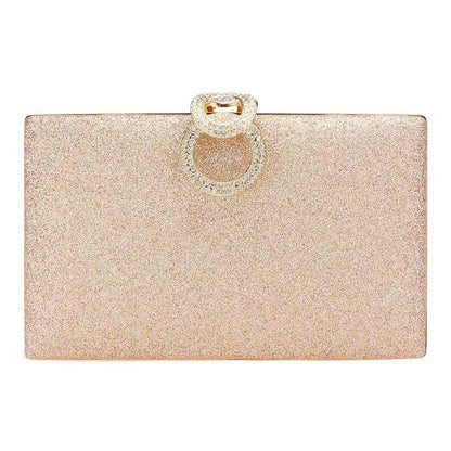 Glittery clutch bag with a decorative ring on a white background
