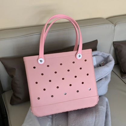 Pink handbag with polka dot pattern on a couch