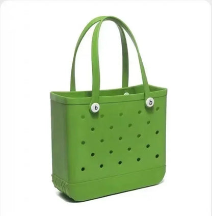 Green tote bag with perforated design and white buttons on a white background