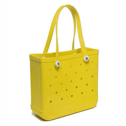 Yellow tote bag with polka dot pattern and brand logo on a white background