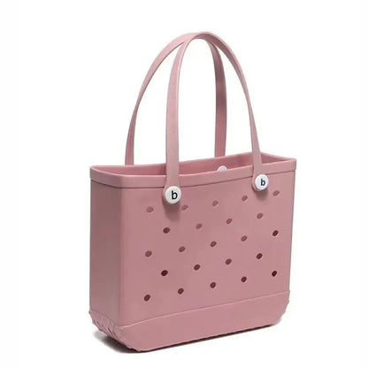 Pink tote bag with polka dot pattern and brand logo on a white background