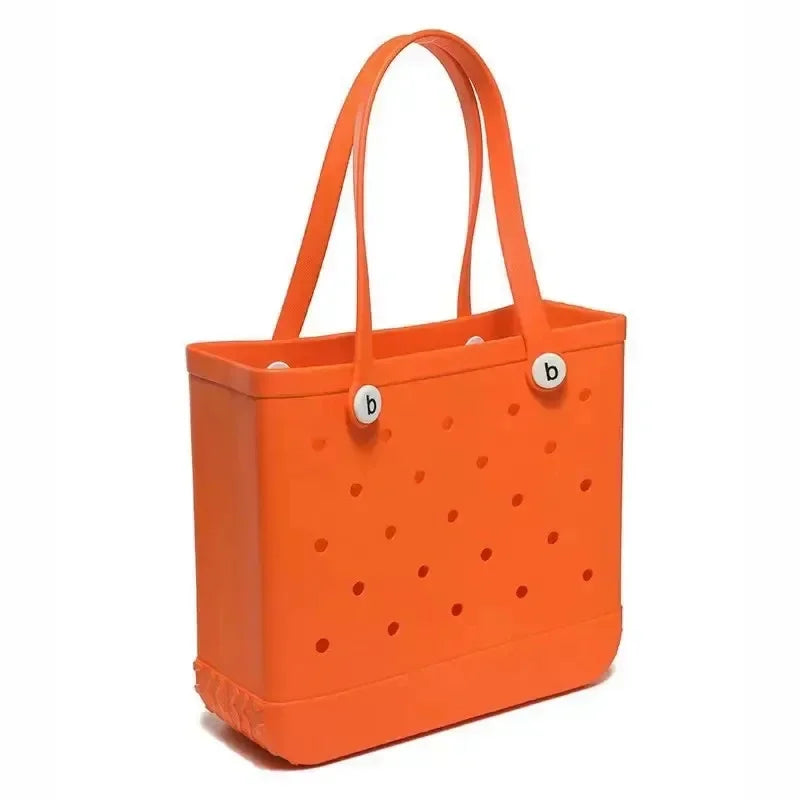 Orange tote bag with polka dot pattern and brand logo on a white background