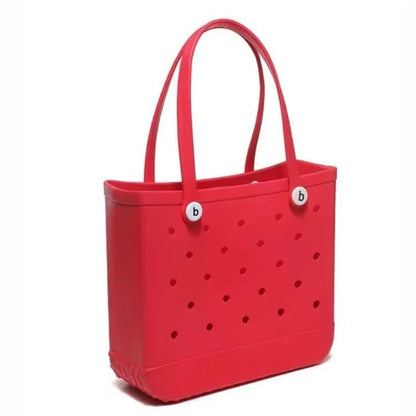 Red tote bag with polka dot pattern and brand logo on a white background