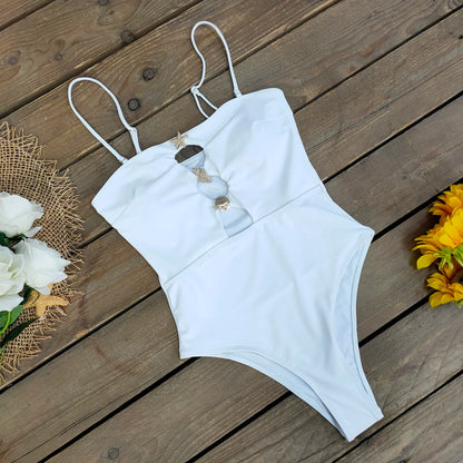 White swimsuit on a wooden surface with flowers