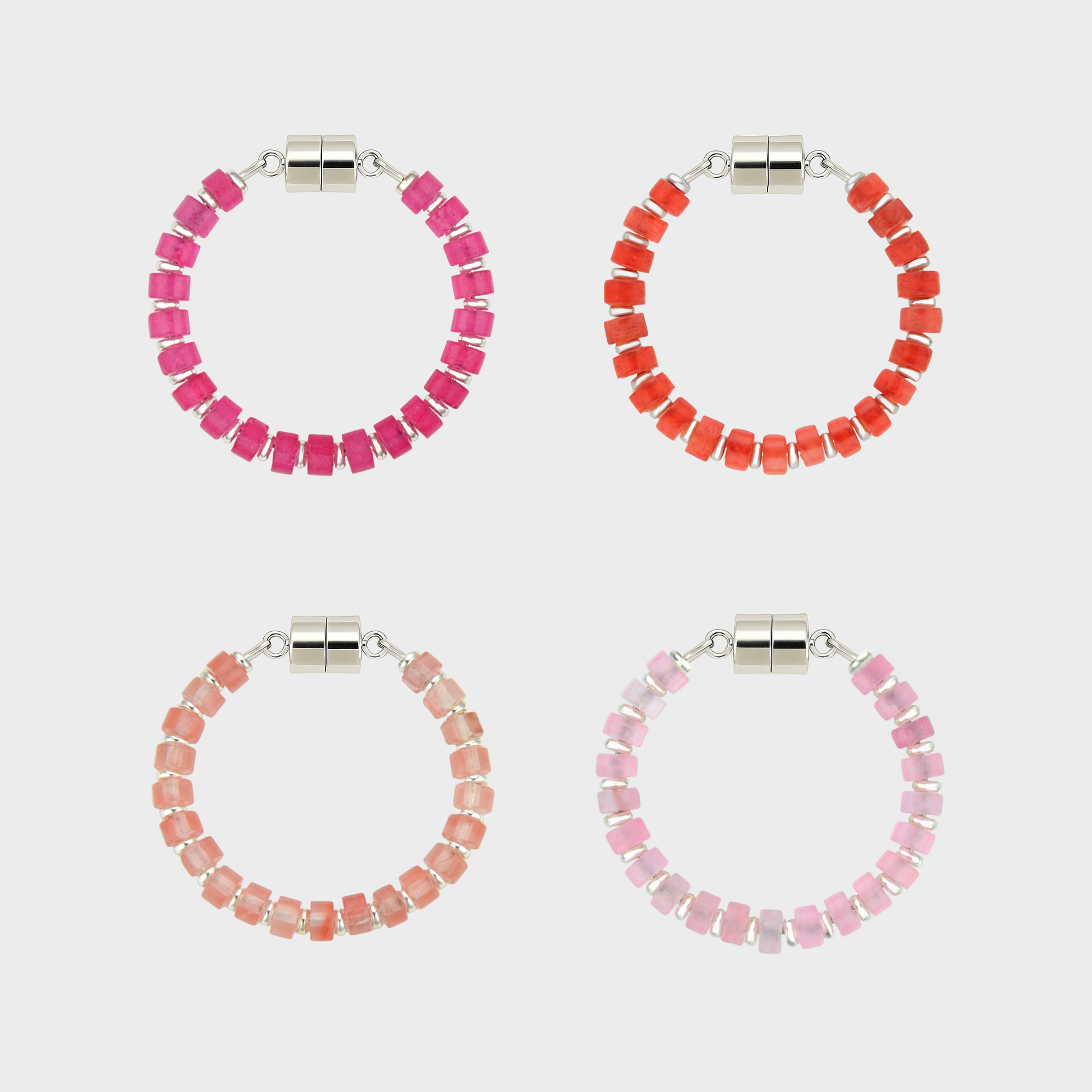 Set of four beaded hoop wine glass markers in pink, red, and peach on a white background