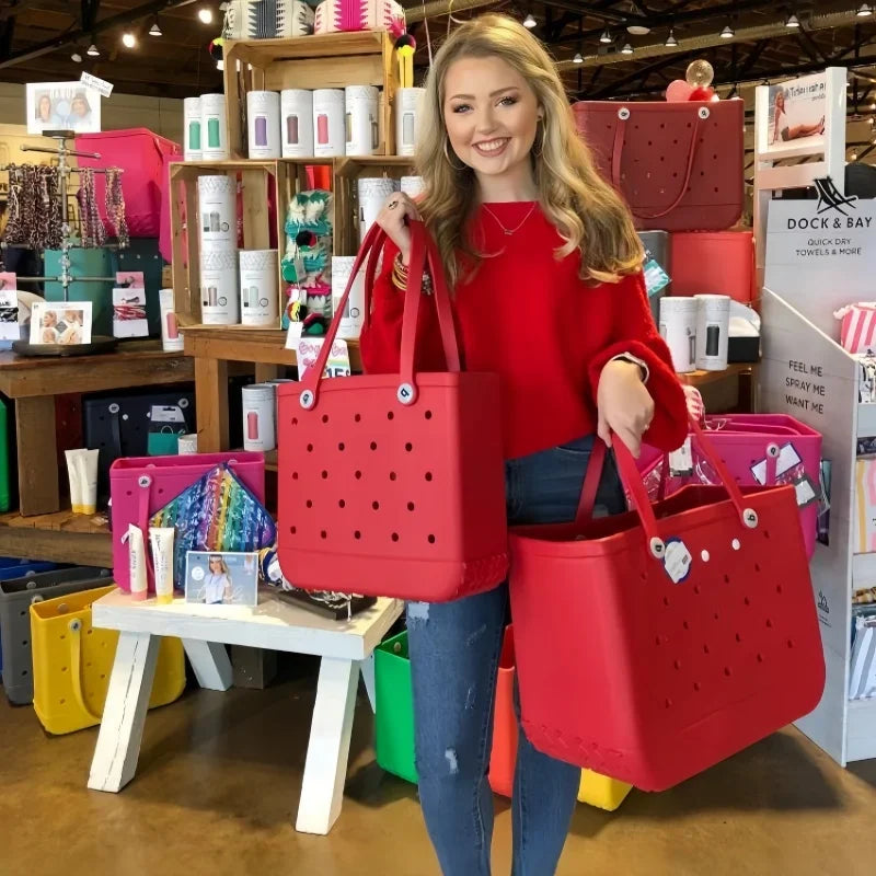 Woman holding two red bags in a store setting with various products and displays.