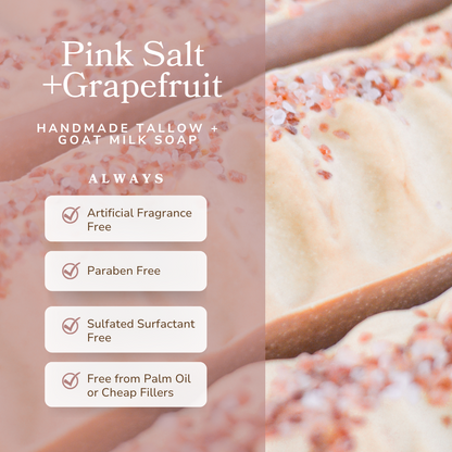 Handmade tallow and goat milk soap with pink salt and grapefruit fragrance, featuring a wooden bar.
