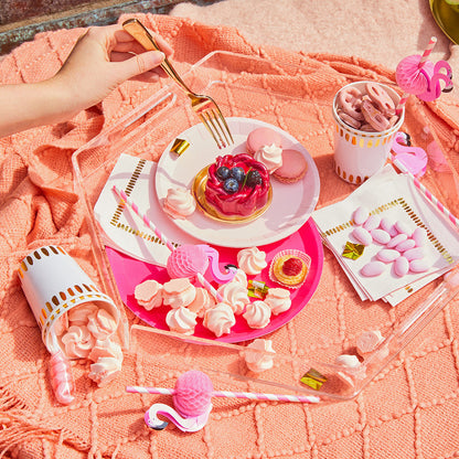 Tropical theme party table setting featuring pink flamingo paper drinking straws.