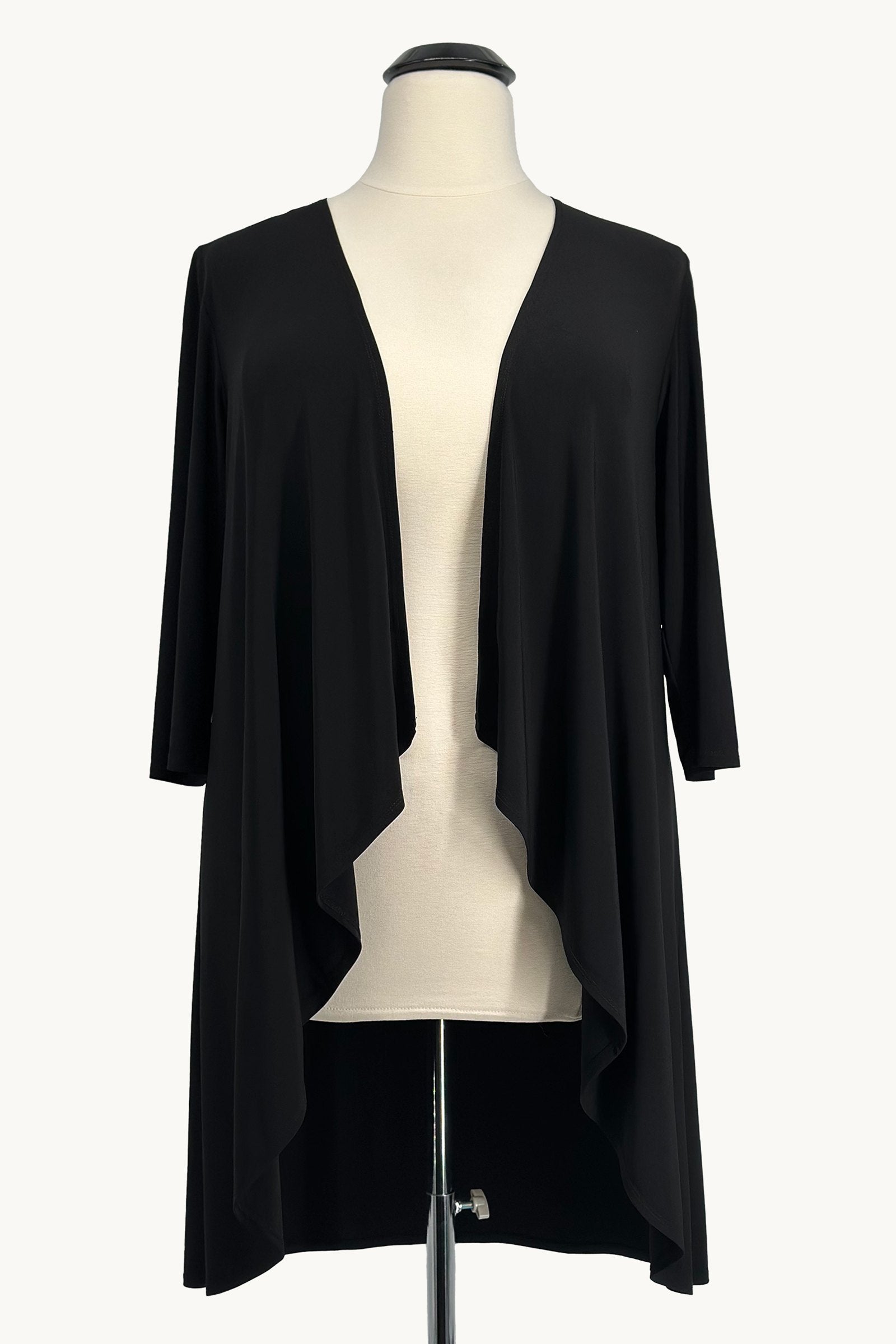 Black cardigan on a mannequin against a white background