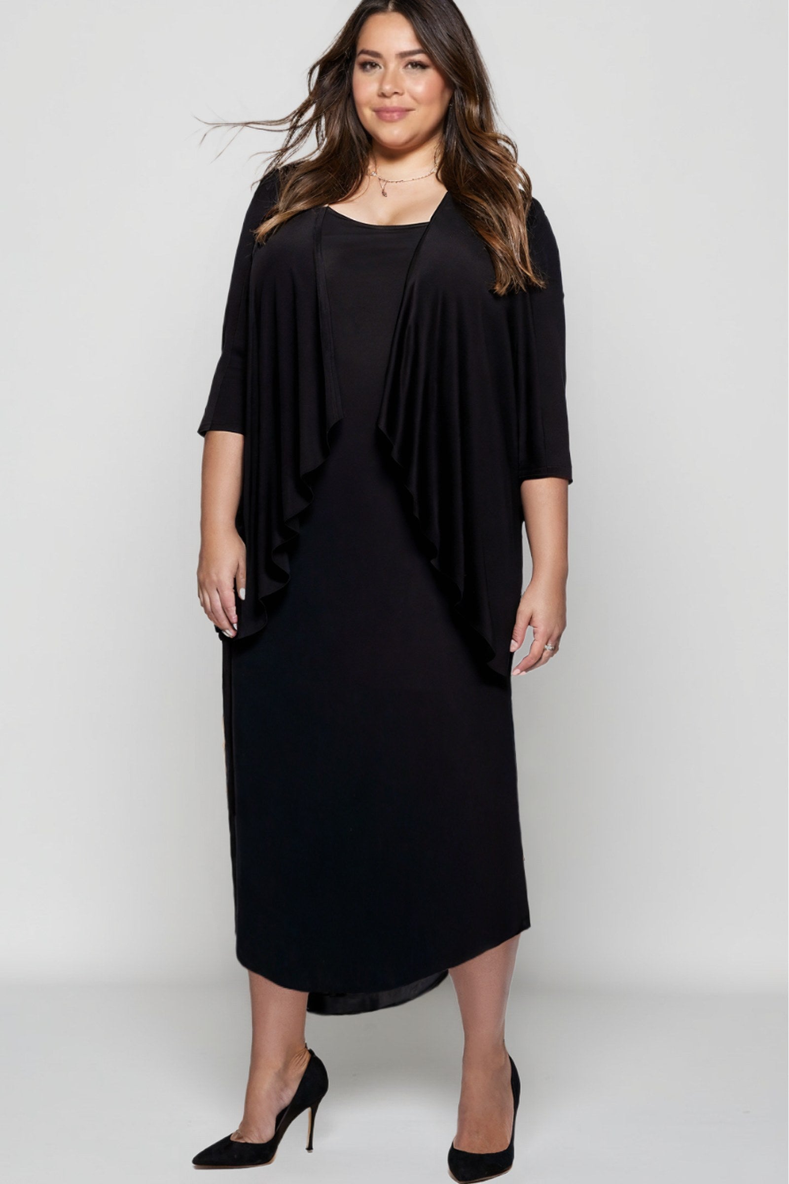 Woman wearing a black dress with a draped effect on a white background