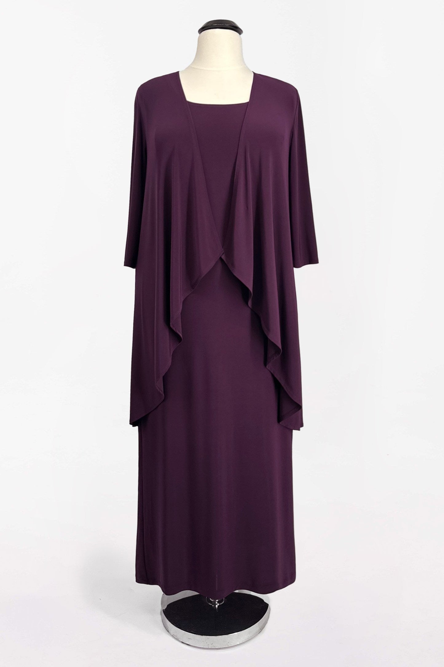 Purple dress with a matching jacket on a mannequin against a white background