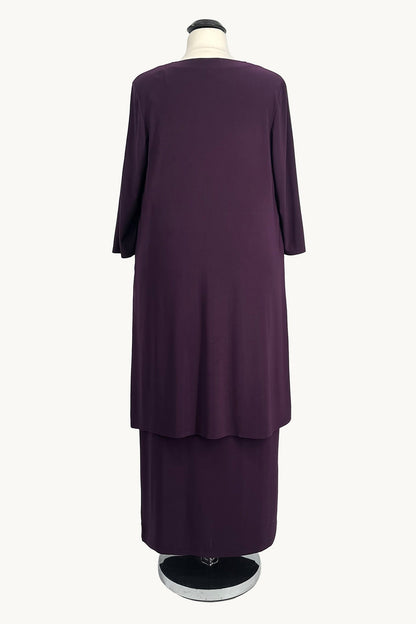Purple dress on a mannequin against a white background