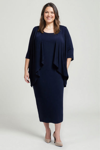 Woman wearing a navy blue dress with a draped effect on a light gray background