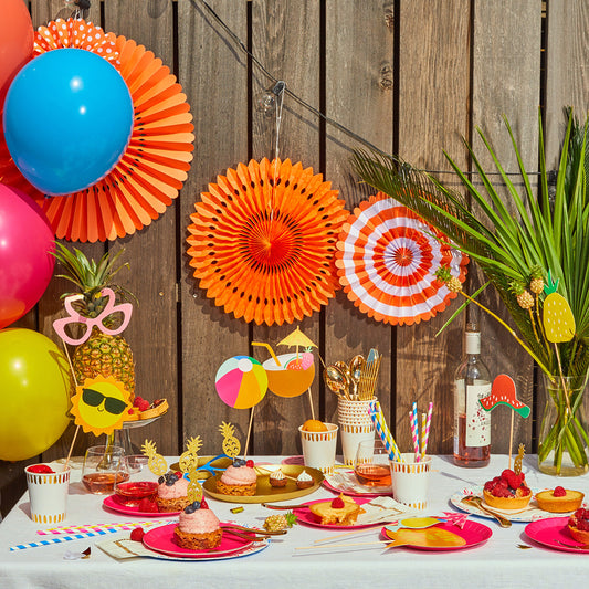 Coral orange fan party decorations.