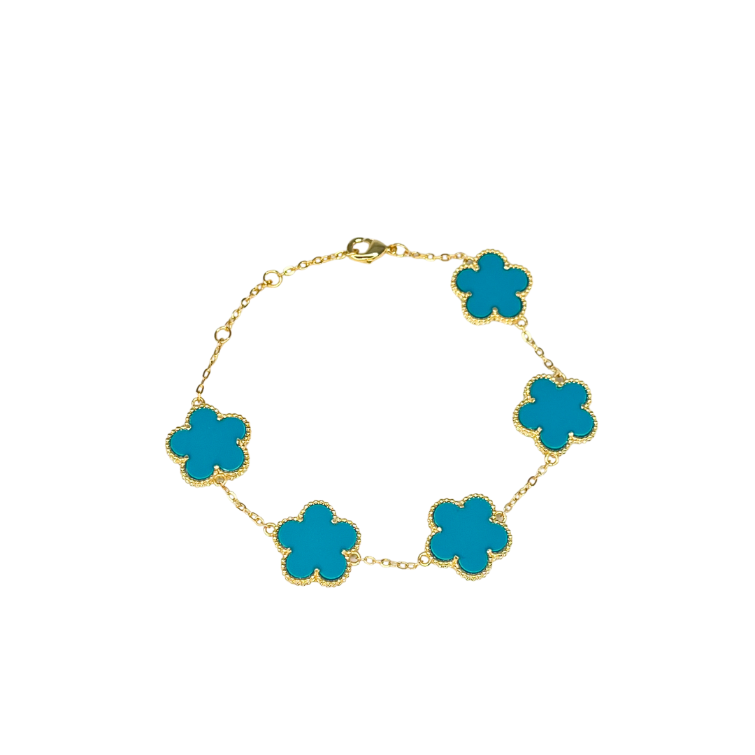 Gold bracelet with turquoise flower-shaped charms on a white background