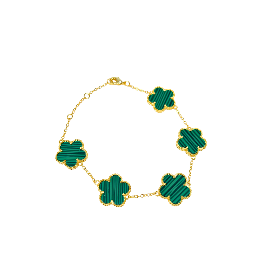 Gold necklace with green clover-shaped links on a white background