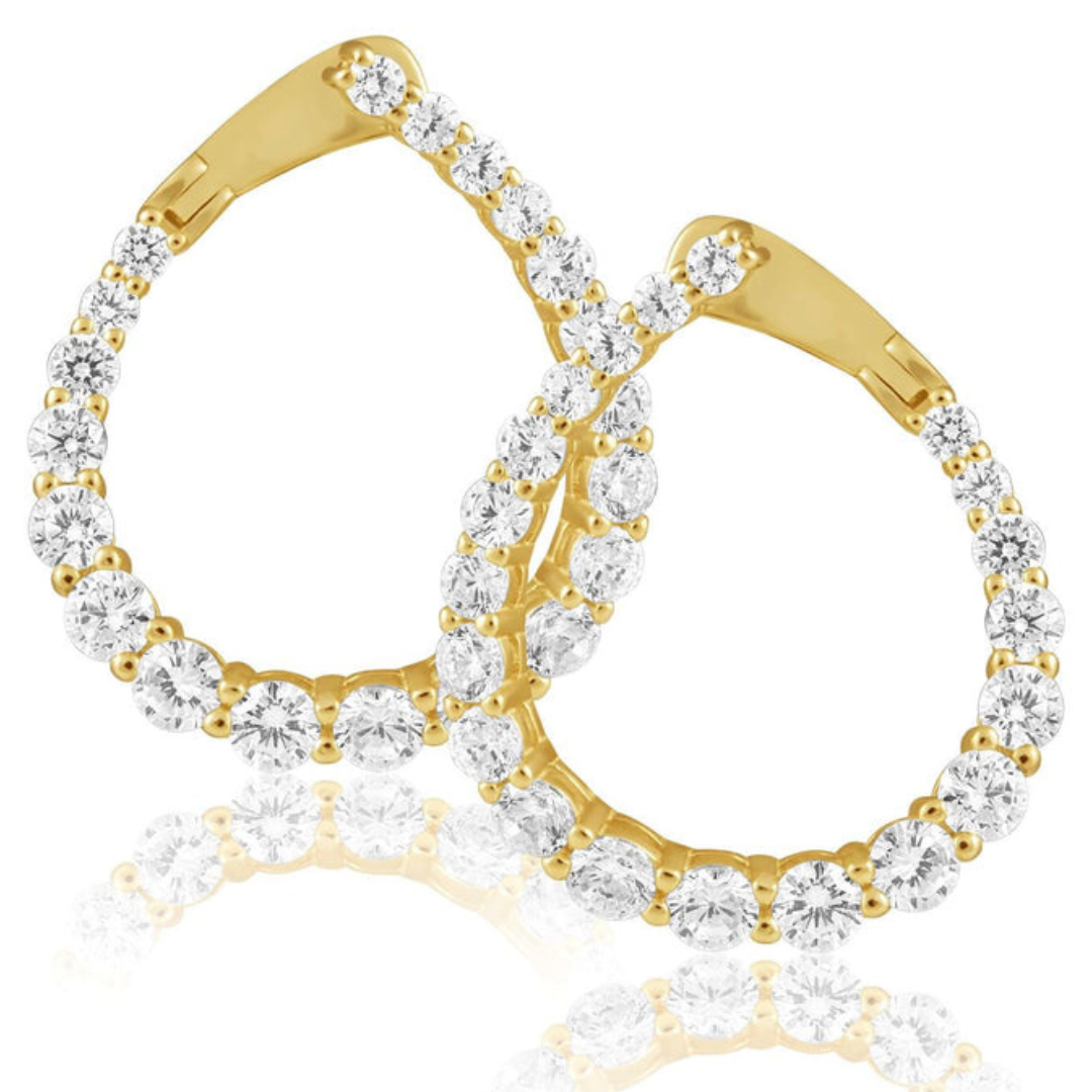 Gold and clear hoop earrings on a white background