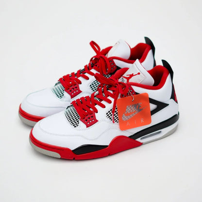 Bold red shoelaces on white and red sneakers with black accents and a tag displaying "Air.