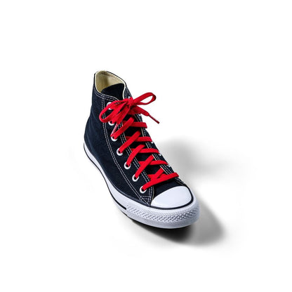 Bold red elastic shoelaces on a black high-top sneaker with white sole and toe cap, positioned on a white background.