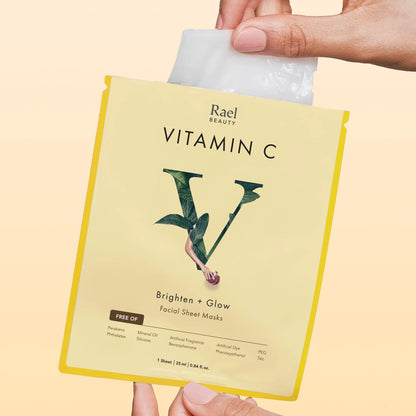 Rael Beauty Vitamin C facial sheet mask packaging held by a hand on a beige background
