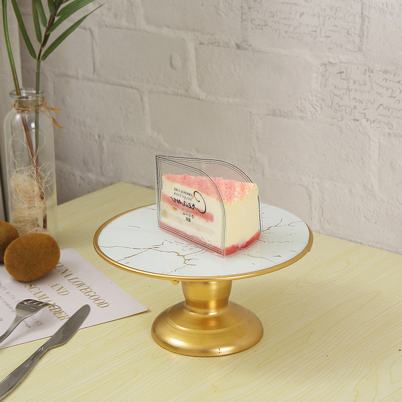 A piece of cake on a marble cake stand