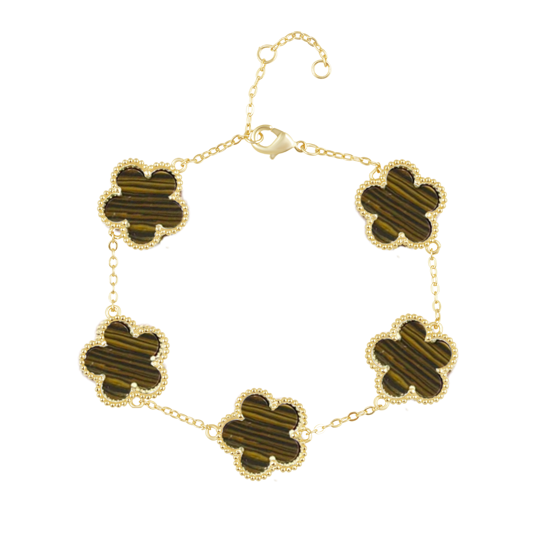 Gold bracelet with four-leaf clover-shaped green stones on a white background