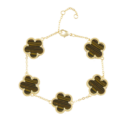 Gold bracelet with four-leaf clover-shaped green stones on a white background