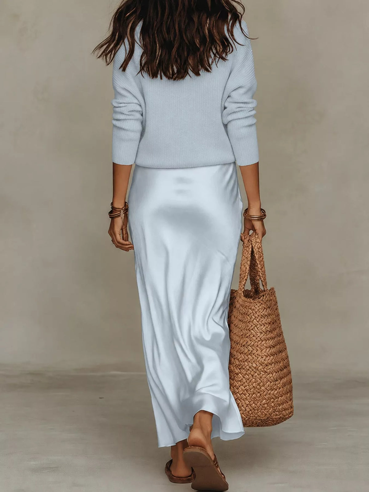  Back view of light blue ribbed top and satin midi skirt set.