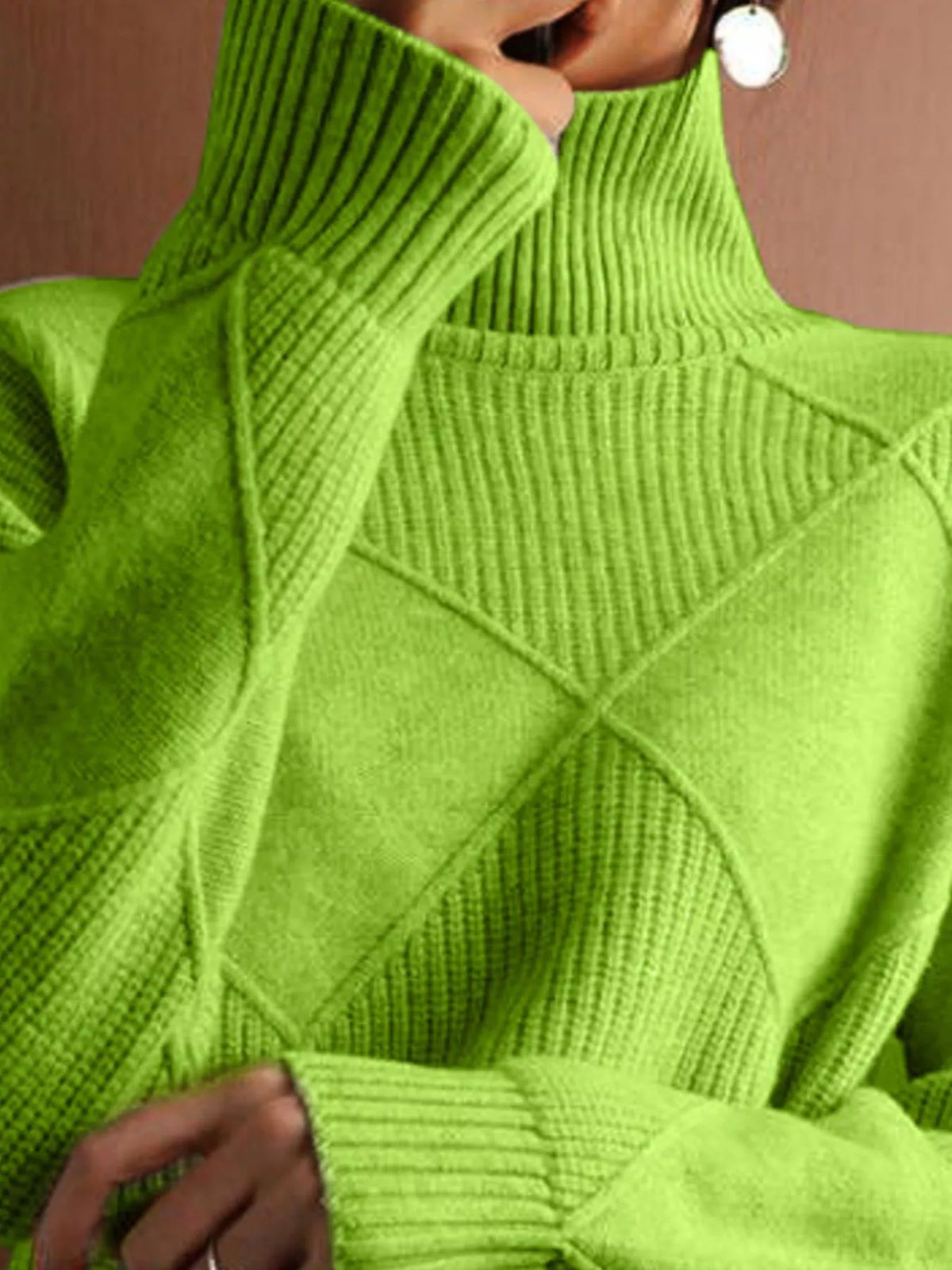 A close-up of a person wearing a bright lime green ribbed turtleneck sweater, showing the textured knit pattern and high collar.
