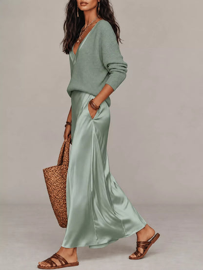 Side view of pale green V-neck top and satin midi skirt, showing the side pocket.