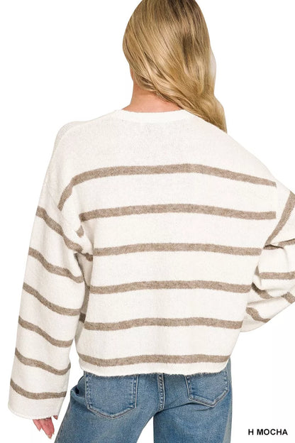 A woman shown from the back wearing a fuzzy knit sweater with horizontal mocha brown stripes on an off-white base, paired with blue jeans.