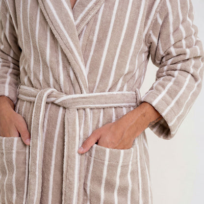 Beige and white striped robe with a belt on a neutral background