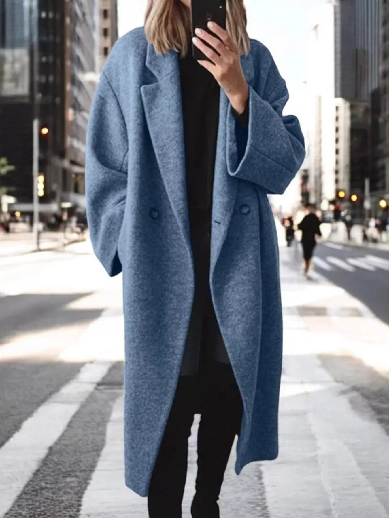 Person wearing a blue coat in an urban setting