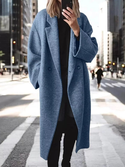 Person wearing a blue coat in an urban setting