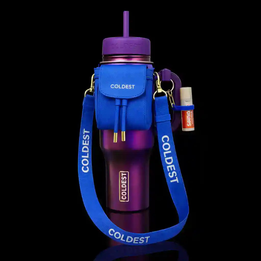Coldest water bottle in purple with a blue mini backpack, squeeze holder, and key hanger attached.