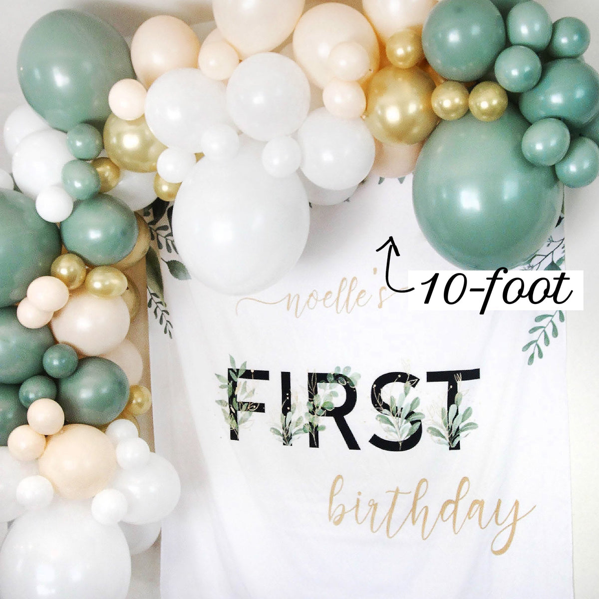 Balloon arch with 'noelle's 10-foot FIRST birthday' text on a white background