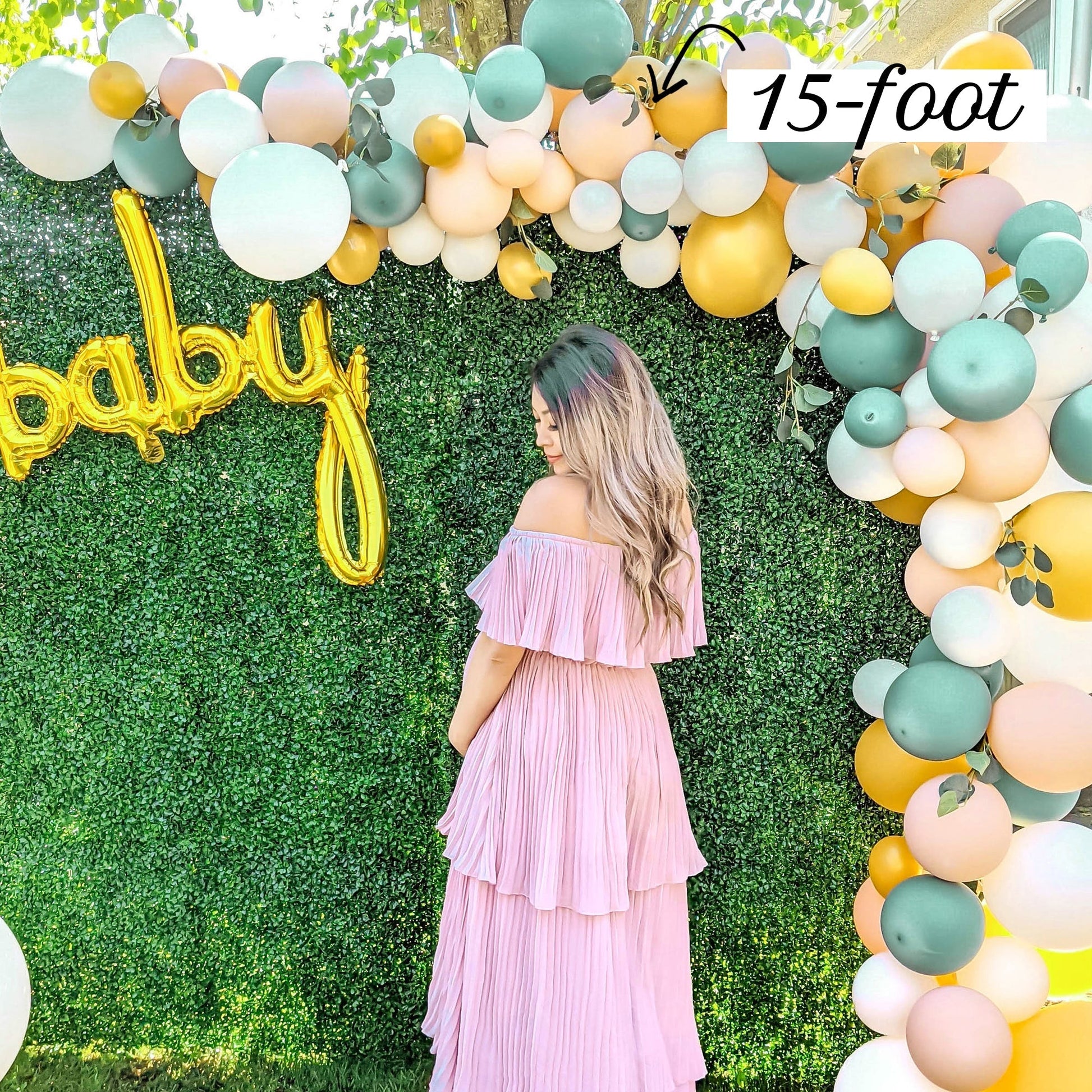 Balloon garland with woman standing under it to show the size.