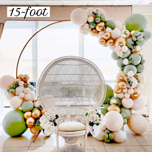 Balloon arch with flowers and a wicker chair in a room.