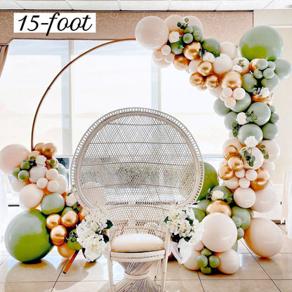 Balloon arch with flowers and a wicker chair in a room.