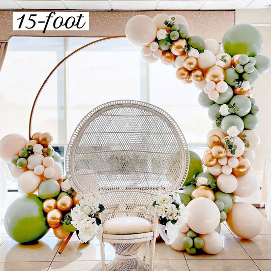 Balloon arch with flowers and a wicker chair in a room.