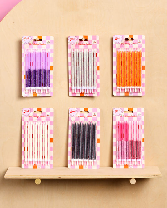 Set of six packages containing colorful needles on a beige background