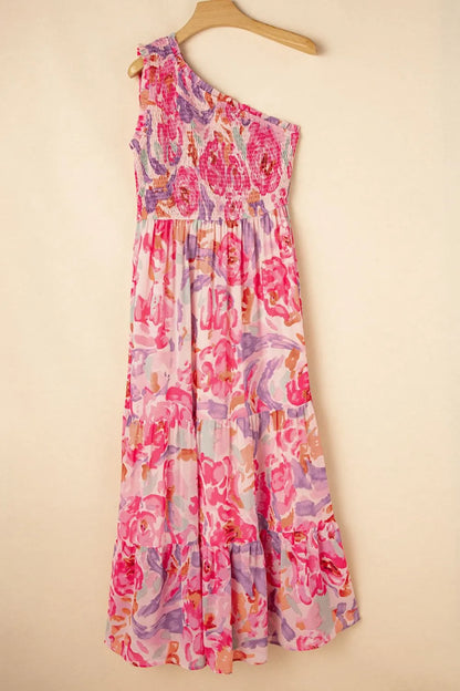 Floral dress hanging on a wooden hanger against a beige background