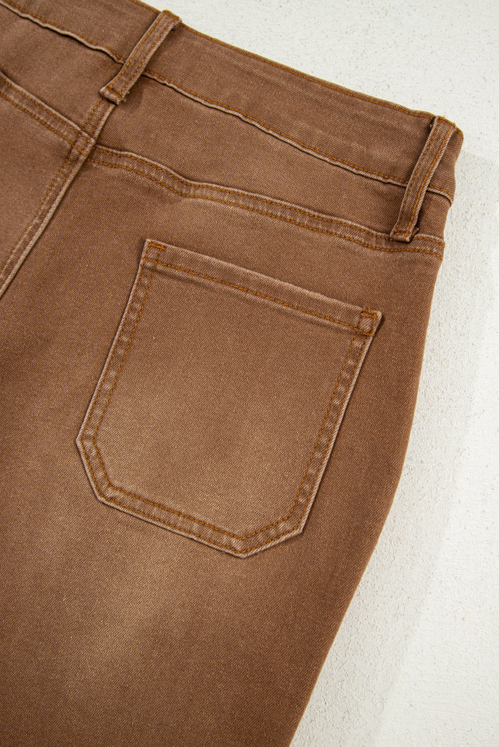 Flat lay of brown wide leg cropped jeans.