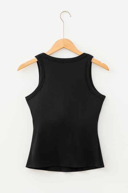 Black ribbed fabric tank top hanging on a light wood hanger against a white wall.