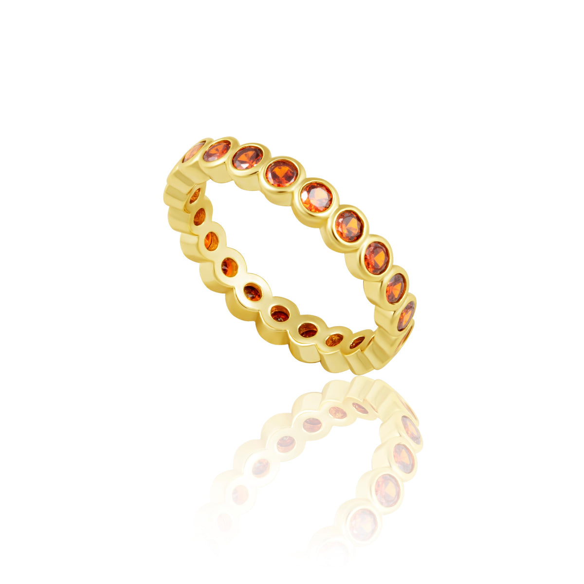 Gold ring with embedded red gemstones on a white background