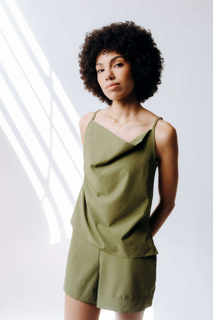 Woman wearing a green outfit against a white background