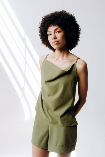 Woman wearing a green outfit against a white background